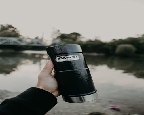 Smiling person enjoying a fresh morning walk holding a reusable water bottle